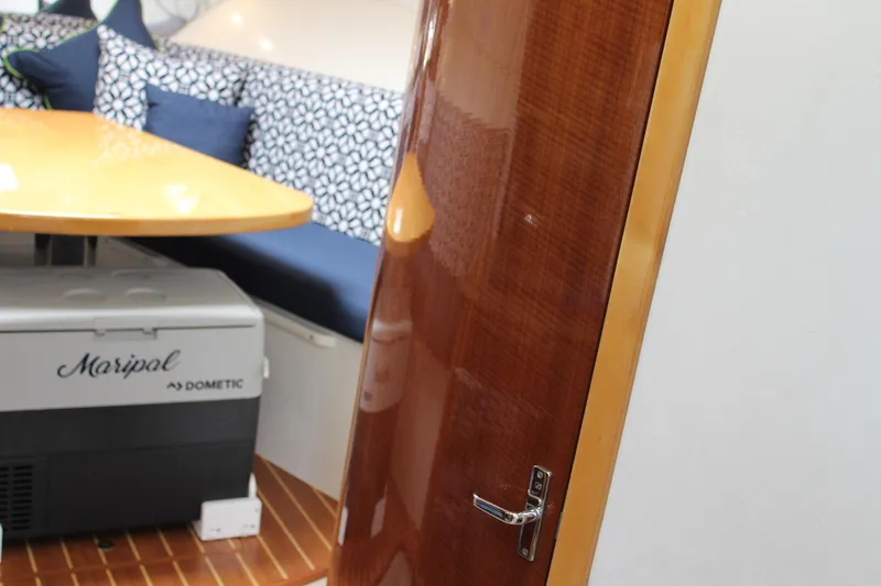 Maripal Yacht Photos Pics Interior of 2008 Contender 38 Express with wooden door, table, and patterned seating.