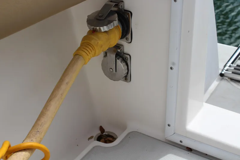 Maripal Yacht Photos Pics Power connection on 2008 Contender 38 Express boat, featuring yellow cable and outlet.