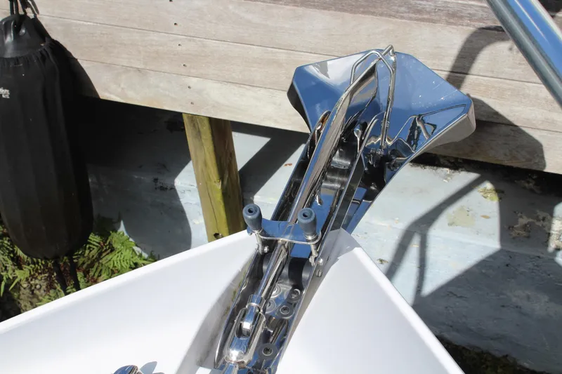 Maripal Yacht Photos Pics Chrome anchor on 2008 Contender 38 Express boat, docked with wooden background.