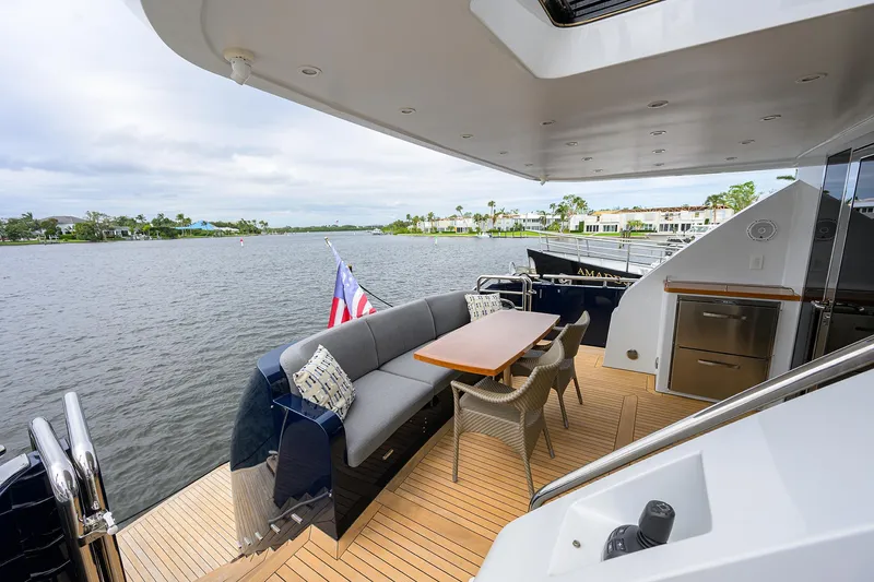 Indigo Yacht Photos Pics Luxurious 2018 Coastal Craft Concord 65 yacht with elegant outdoor seating and scenic water view.