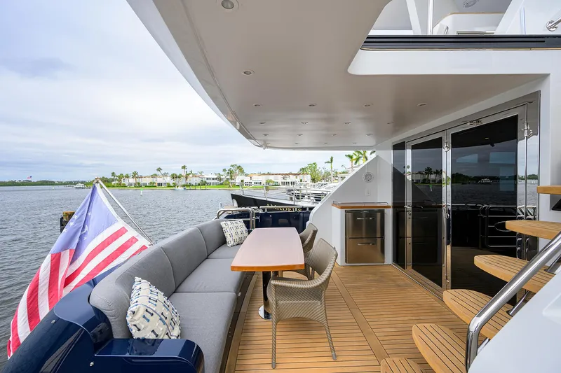 Indigo Yacht Photos Pics Luxurious 2018 Coastal Craft Concord 65 yacht with elegant outdoor seating and scenic water view.