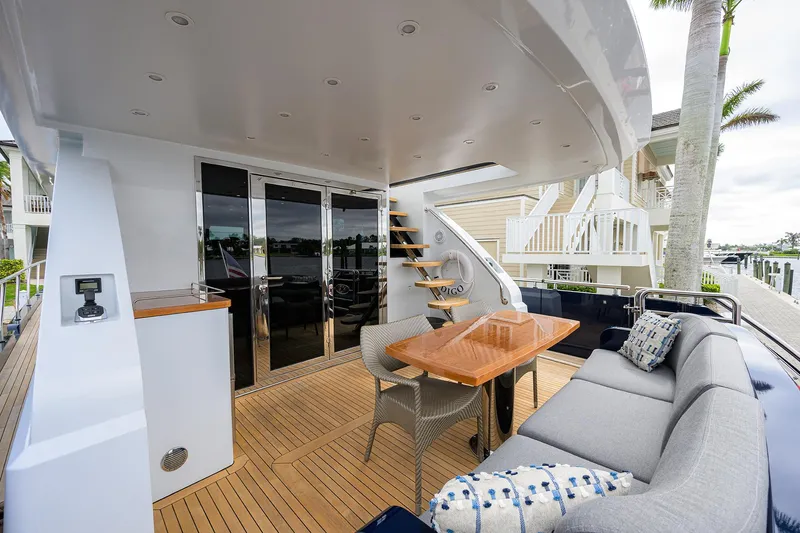 Indigo Yacht Photos Pics Luxurious 2018 Coastal Craft Concord 65 yacht deck with seating and dining area.