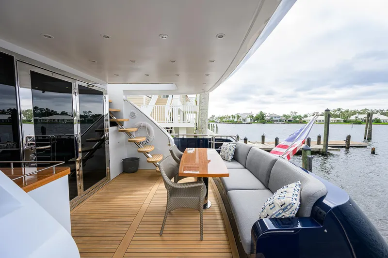 Indigo Yacht Photos Pics Luxurious 2018 Coastal Craft Concord 65 yacht deck with seating and scenic waterfront view.