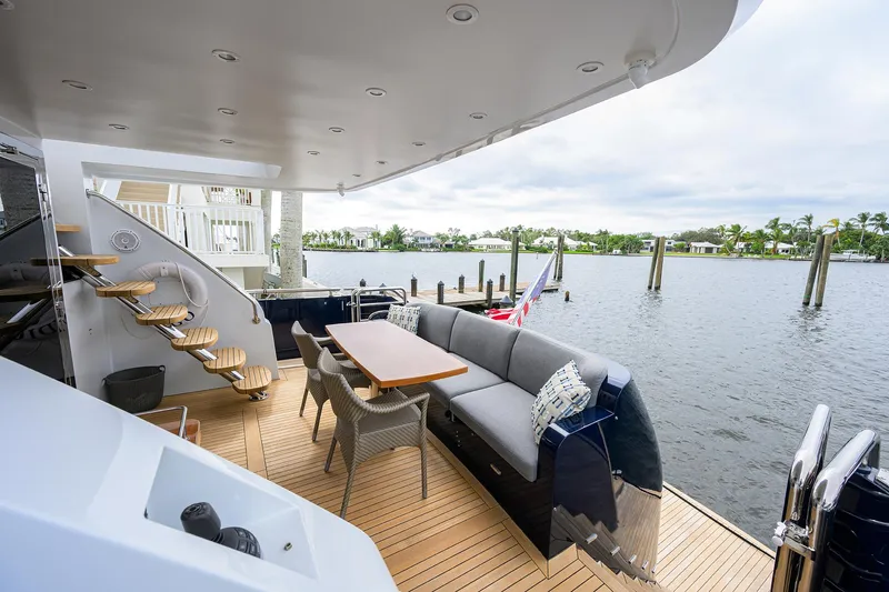 Indigo Yacht Photos Pics Luxurious 2018 Coastal Craft Concord 65 yacht deck with seating and scenic waterfront view.