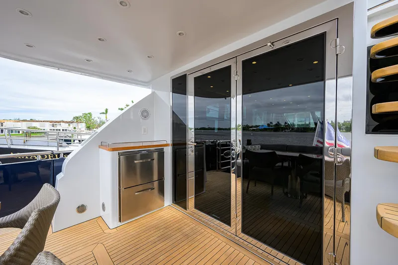 Indigo Yacht Photos Pics Luxurious 2018 Coastal Craft Concord 65 yacht deck with glass doors and modern amenities.