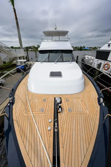 Indigo Yacht Photos Pics 2018 Coastal Craft Concord 65 yacht with sleek wooden deck and modern design.