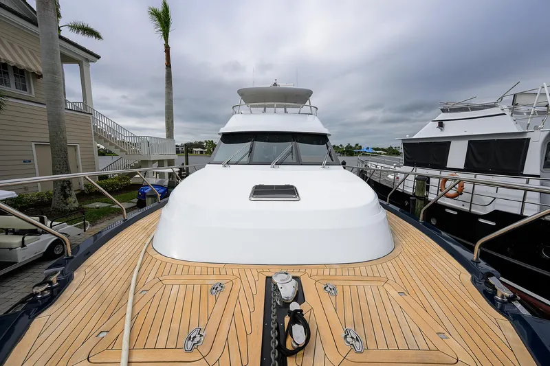 Indigo Yacht Photos Pics 2018 Coastal Craft Concord 65 yacht with teak deck, docked at marina.