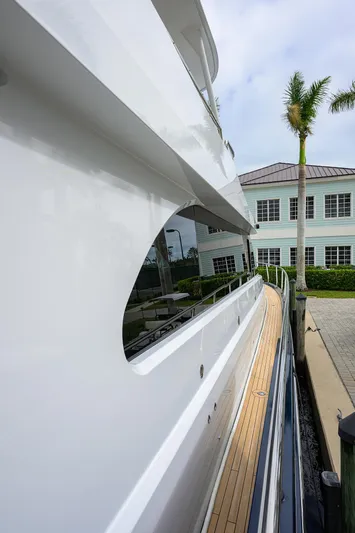 Indigo Yacht Photos Pics 2018 Coastal Craft Concord 65 yacht docked near a waterfront building.