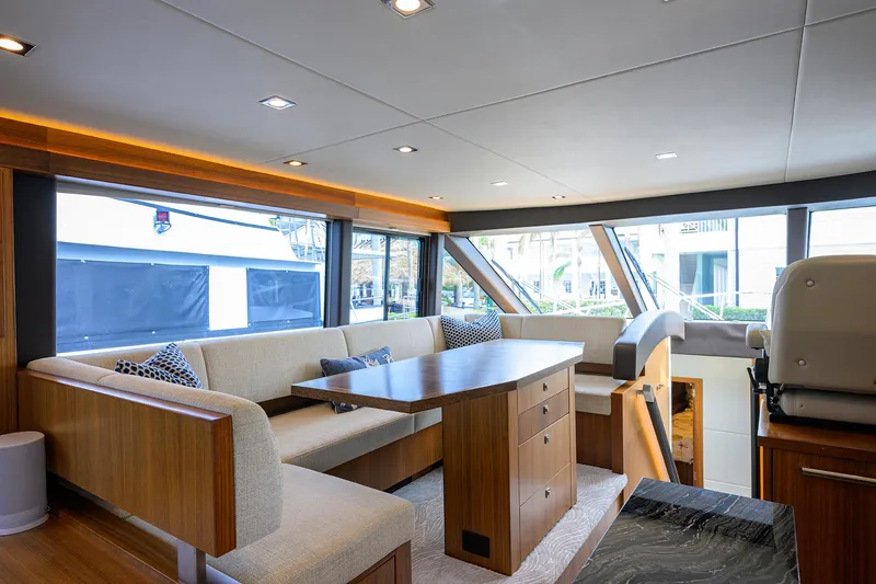 Indigo Yacht Photos Pics Luxurious interior of 2018 Coastal Craft Concord 65 yacht with elegant seating and dining area.