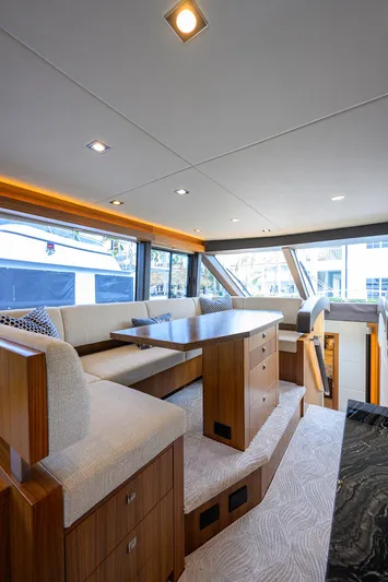 Indigo Yacht Photos Pics Luxurious interior of 2018 Coastal Craft Concord 65 yacht with modern seating and elegant design.