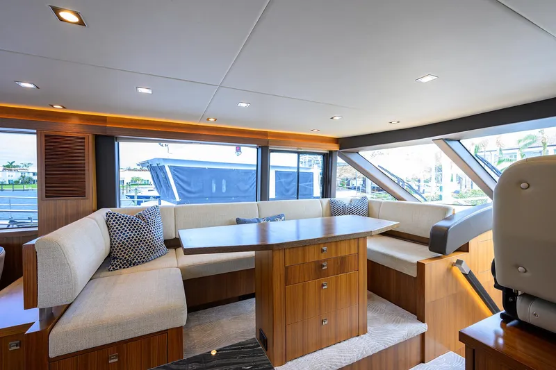 Indigo Yacht Photos Pics Luxurious interior of 2018 Coastal Craft Concord 65 yacht with elegant seating and wooden finishes.