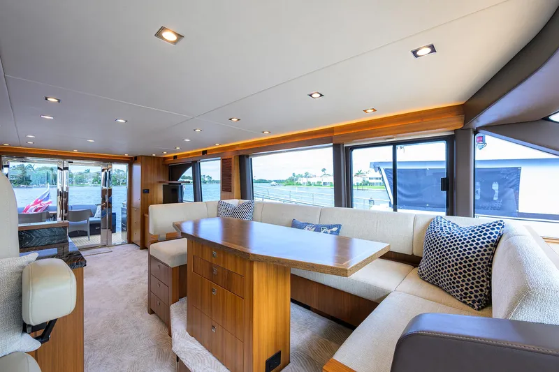 Indigo Yacht Photos Pics Luxurious interior of 2018 Coastal Craft Concord 65 yacht with elegant seating and panoramic windows.