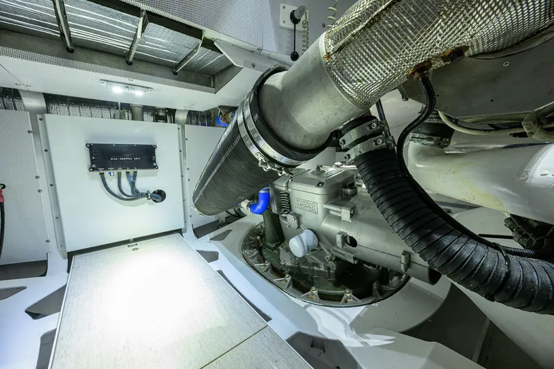 Indigo Yacht Photos Pics Engine room of 2018 Coastal Craft Concord 65 yacht, showcasing mechanical components and piping.