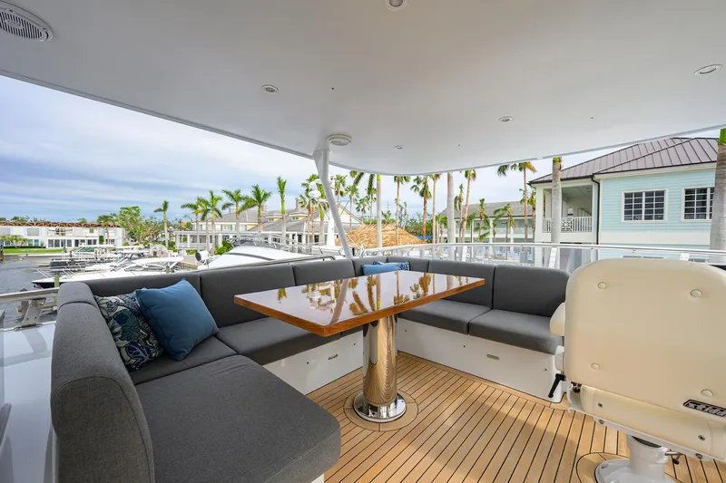 Indigo Yacht Photos Pics Luxurious 2018 Coastal Craft Concord 65 yacht deck with elegant seating and table.