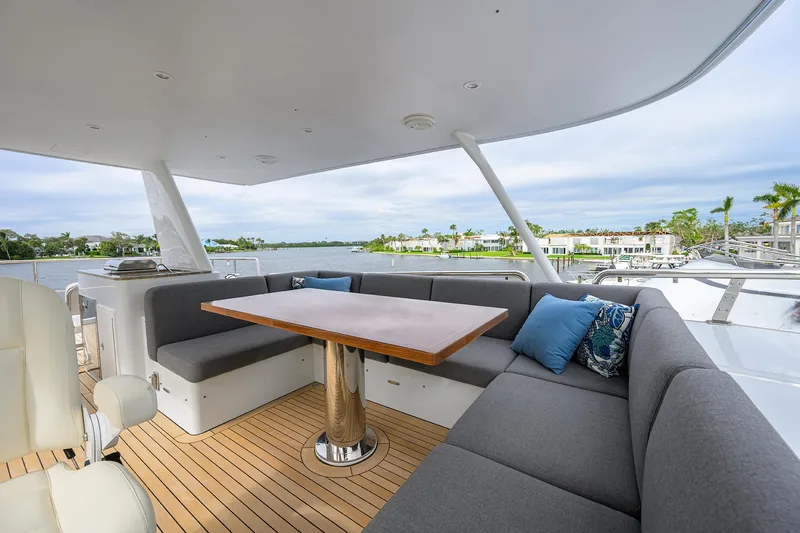 Indigo Yacht Photos Pics Luxurious 2018 Coastal Craft Concord 65 yacht deck with elegant seating and scenic waterfront view.