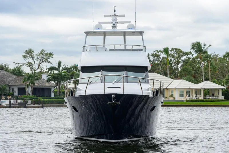 Indigo Yacht Photos Pics 2018 Coastal Craft Concord 65 yacht on a serene waterway.