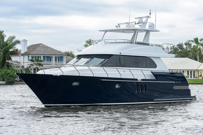 Indigo Yacht Photos Pics 2018 Coastal Craft Concord 65 yacht cruising on a serene waterway.