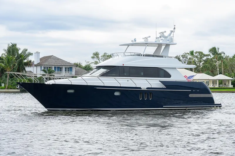 Indigo Yacht Photos Pics 2018 Coastal Craft Concord 65 yacht on a serene waterway.