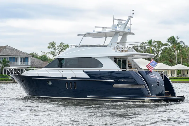 Indigo Yacht Photos Pics Luxury 2018 Coastal Craft Concord 65 yacht cruising on a serene waterway.