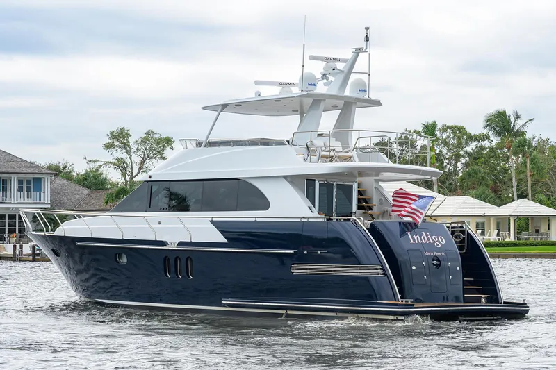 Indigo Yacht Photos Pics Luxury 2018 Coastal Craft Concord 65 yacht cruising on a serene waterway.