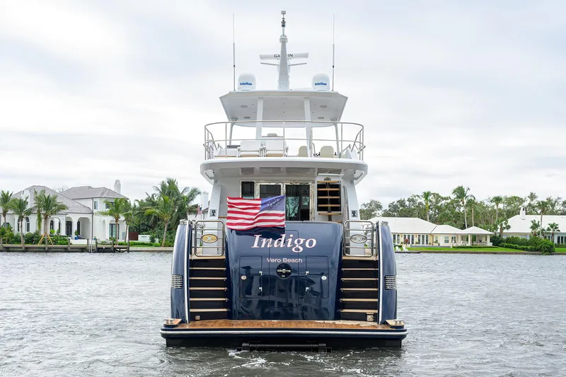 Indigo Yacht Photos Pics 2018 Coastal Craft Concord 65 yacht on water, rear view with American flag.