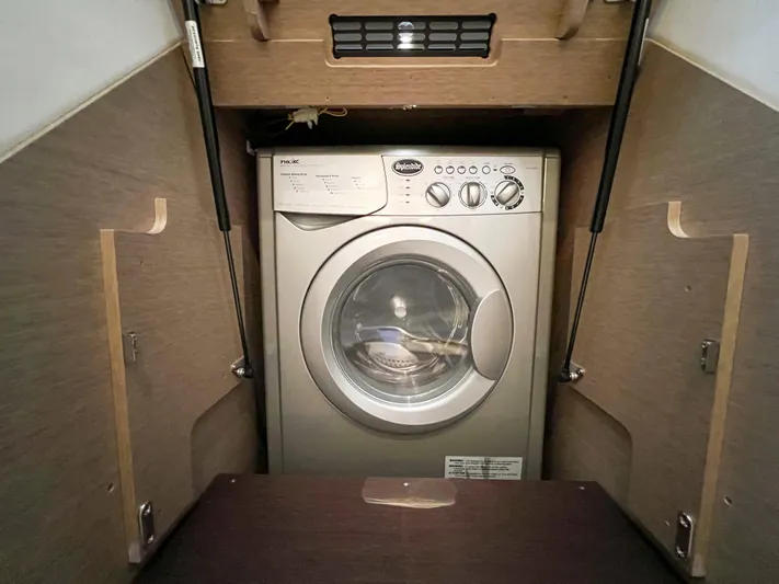  Yacht Photos Pics Washing machine inside a 2020 Prestige 520S yacht's wooden cabinet.