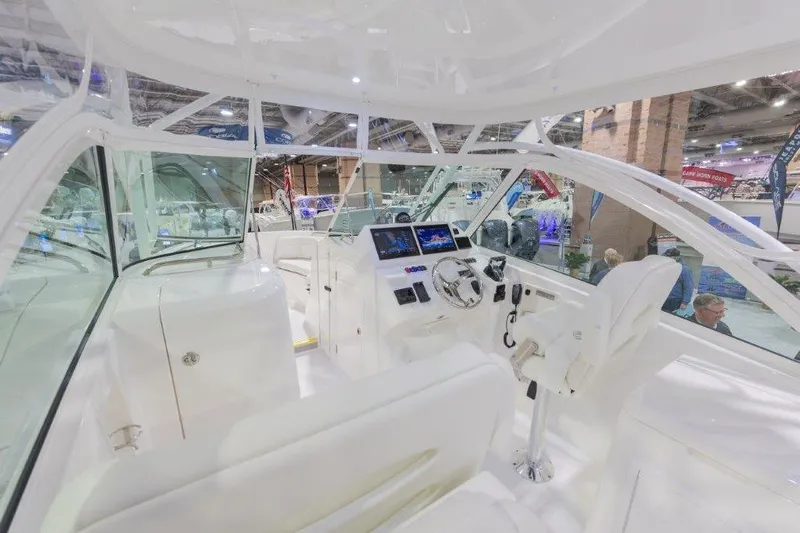 2026 27' Albemarle Dual Console Yacht Photos Pics 2026 Albemarle 27 Dual Console boat interior at a boat show, featuring modern controls.