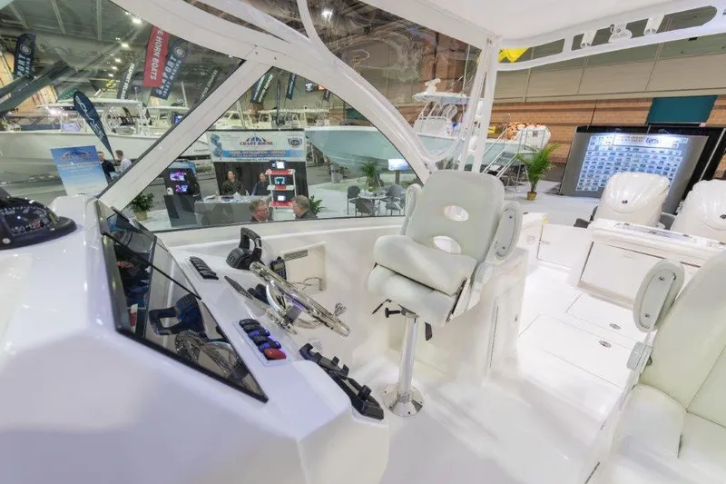 2026 27' Albemarle Dual Console Yacht Photos Pics 2026 Albemarle 27 Dual Console interior at a boat show, featuring helm and seating area.