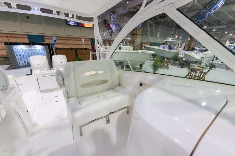 2026 27' Albemarle Dual Console Yacht Photos Pics 2026 Albemarle 27 Dual Console interior at a boat show, featuring seating and modern design.