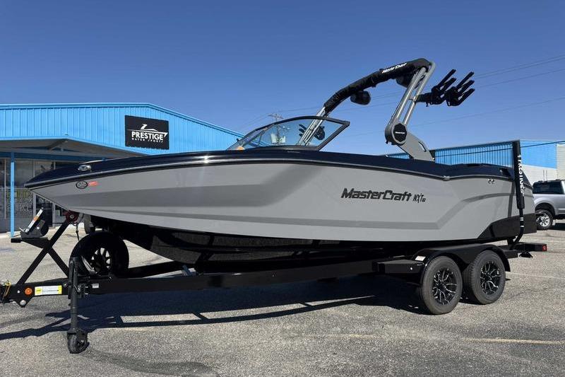 2026 MasterCraft NXT22 boat on trailer outside Prestige dealership.