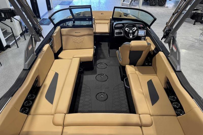 2026 MasterCraft NXT22 boat interior with tan seating and modern dashboard design.