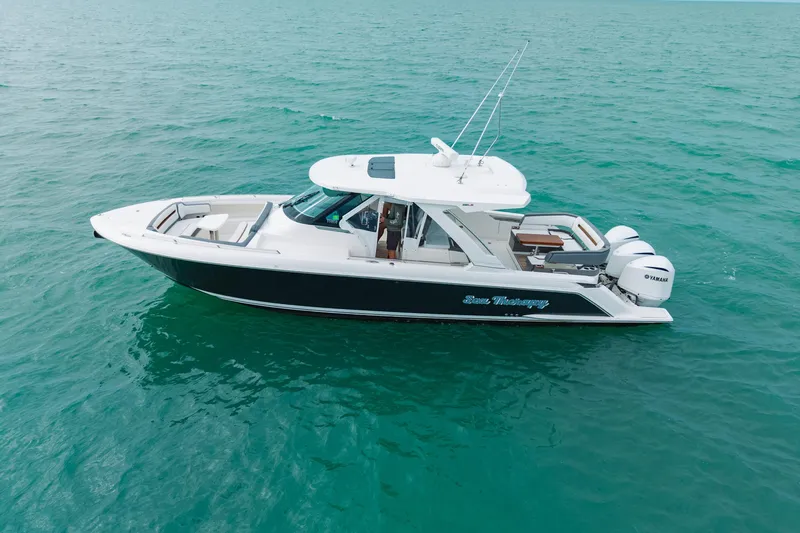  Yacht Photos Pics 2020 Tiara Sport 38 LS boat cruising on clear blue water.