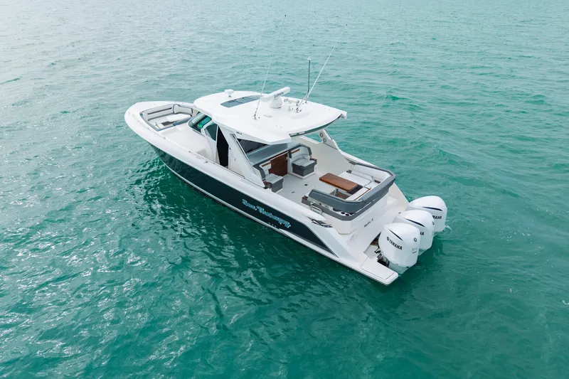  Yacht Photos Pics 2020 Tiara Sport 38 LS boat on turquoise water, featuring triple Yamaha engines.