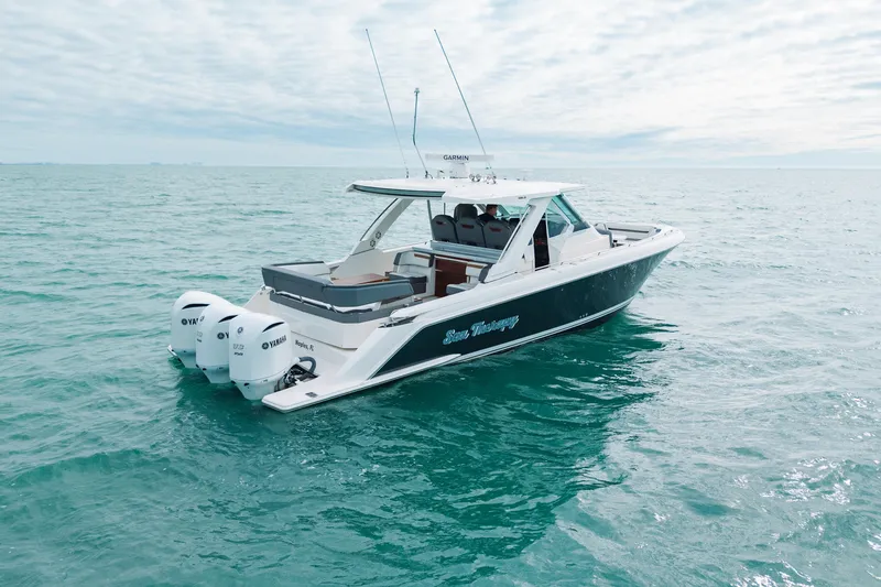  Yacht Photos Pics 2020 Tiara Sport 38 LS boat on open water, featuring triple Yamaha engines.