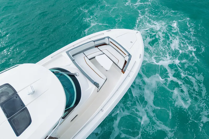 Yacht Photos Pics Aerial view of 2020 Tiara Sport 38 LS yacht cruising in turquoise waters.