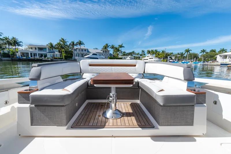  Yacht Photos Pics 2020 Tiara Sport 38 LS yacht interior with elegant seating and table, docked by waterfront homes.