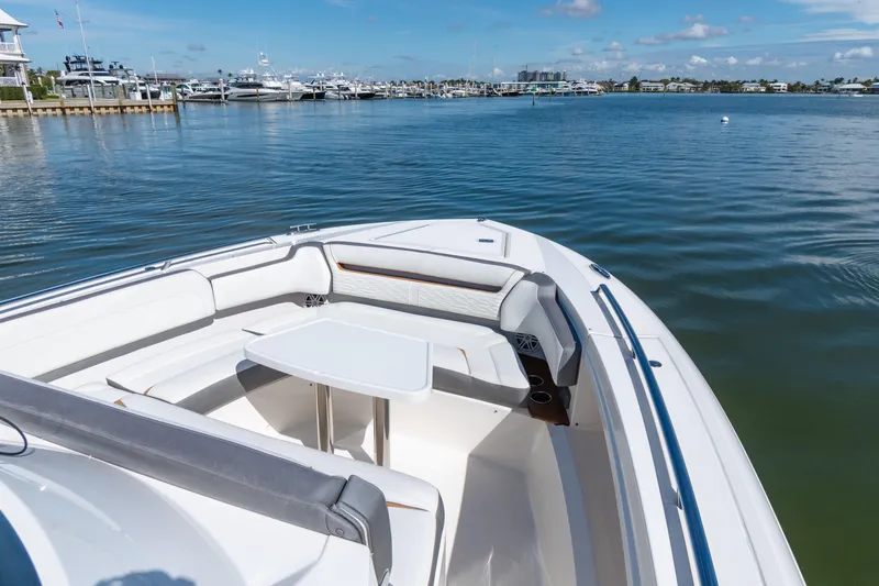  Yacht Photos Pics 2020 Tiara Sport 38 LS boat with seating area and table on calm water.