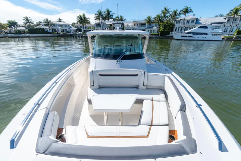  Yacht Photos Pics 2020 Tiara Sport 38 LS boat with luxurious seating, docked near waterfront homes.