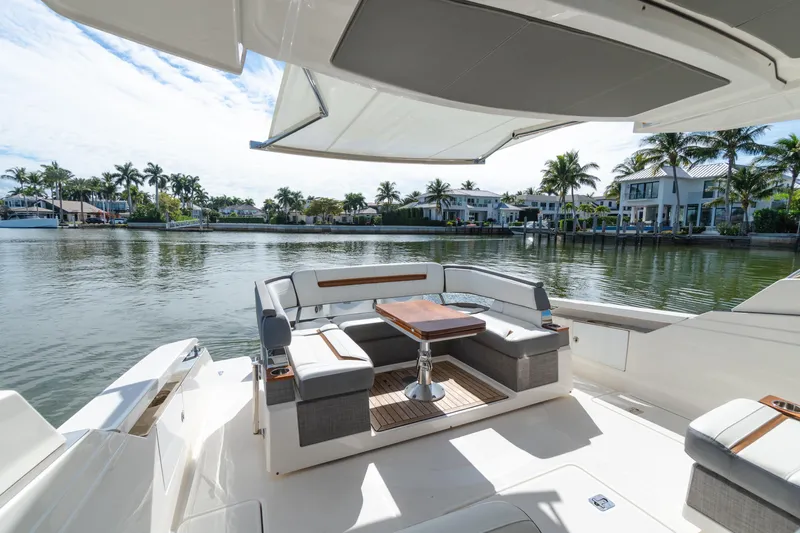  Yacht Photos Pics 2020 Tiara Sport 38 LS yacht with elegant seating, docked by waterfront homes.