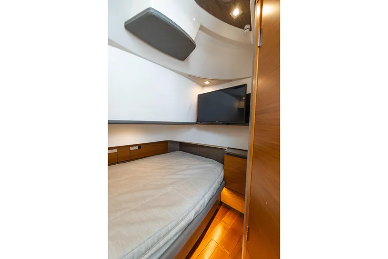  Yacht Photos Pics 2020 Tiara Sport 38 LS cabin interior with bed, TV, and wooden accents.