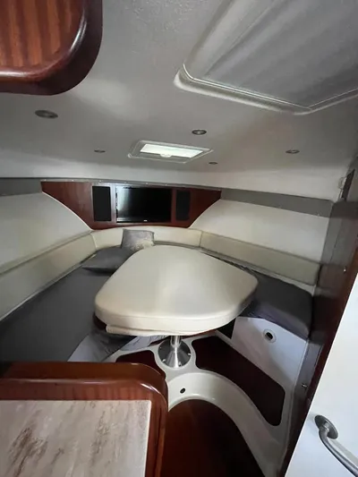 No Name Yacht Photos Pics 2019 Pursuit OS 385 Offshore cabin interior with seating and table.