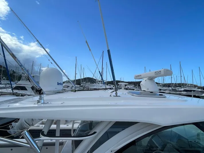 No Name Yacht Photos Pics 2019 Pursuit OS 385 Offshore boat docked, featuring radar and antennas under a clear blue sky.