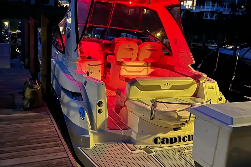  Yacht Photos Pics 2009 Monterey 340 Sport Yacht docked at night with red interior lighting.