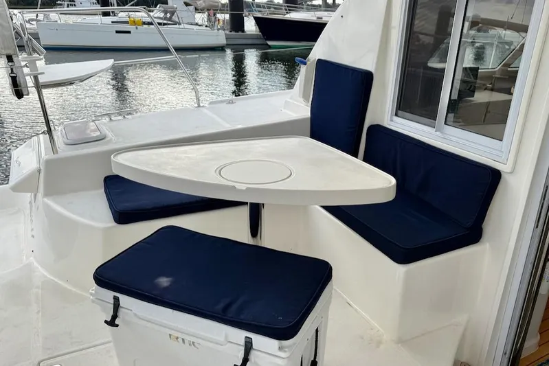 Zimbini Yacht Photos Pics Outdoor seating area on a 2006 Island Spirit 401 yacht with blue cushions.
