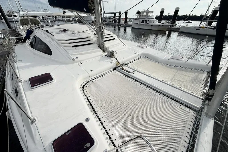 Zimbini Yacht Photos Pics 2006 Island Spirit 401 catamaran docked, featuring spacious deck and netting.