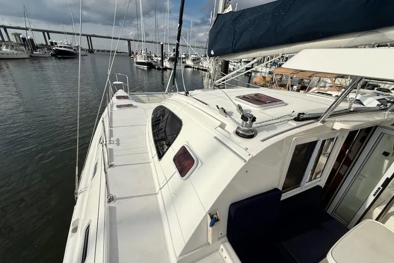 Zimbini Yacht Photos Pics Sailboat Island Spirit 401, 2006 model, docked in a marina with bridge in background.
