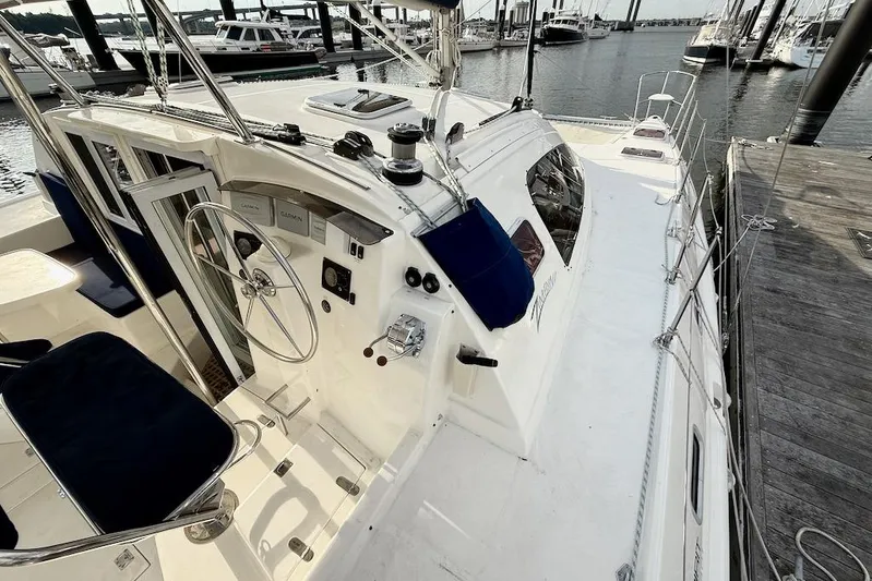 Zimbini Yacht Photos Pics 2006 Island Spirit 401 sailboat docked, featuring helm and navigation equipment.