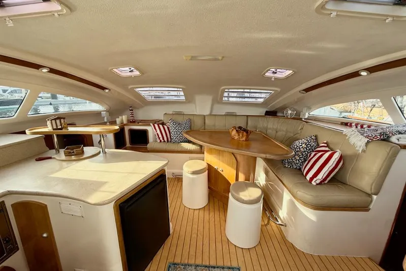 Zimbini Yacht Photos Pics Luxurious interior of 2006 Island Spirit 401 yacht with plush seating and elegant decor.