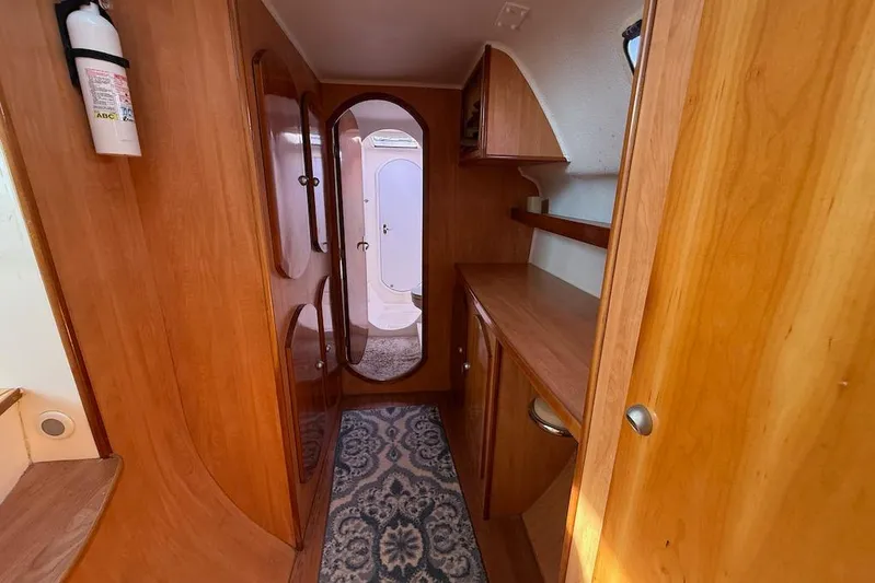 Zimbini Yacht Photos Pics Interior of 2006 Island Spirit 401 yacht with wooden cabinetry and carpeted floor.