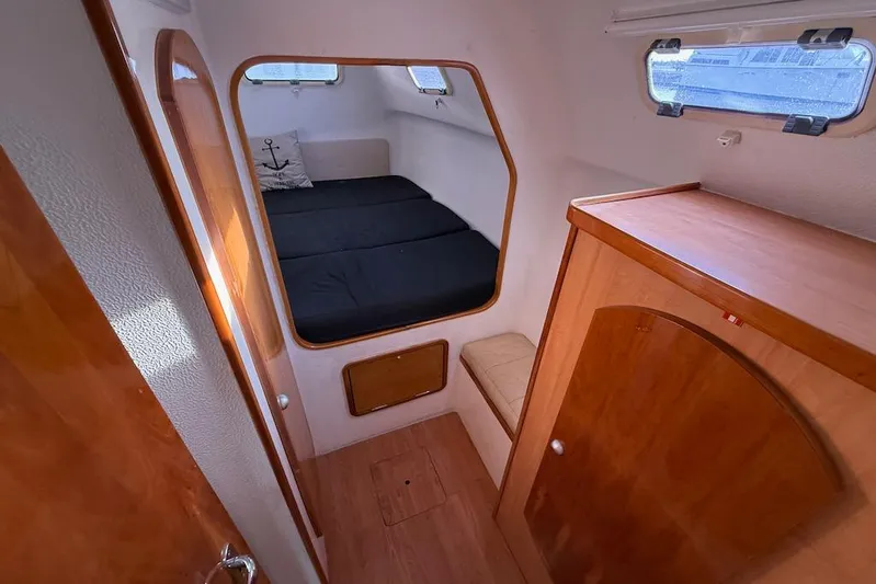 Zimbini Yacht Photos Pics Interior cabin of 2006 Island Spirit 401 yacht with wooden finishes and cozy bed.